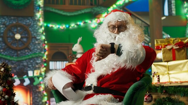 Person in Christmas costume alerted after dozing off and running late on delivering gifts to children. Santa Claus waking up after falling asleep on armchair while reading letters from kids, camera A