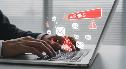 Businessman typing on a laptop with a digital warning and email notification overlay