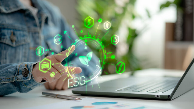 Hand touching ESG icon with green energy, CO2, recycling, and mobility symbols on virtual interface. Concept of digital ESG strategy, environmental responsibility, and sustainability tech.