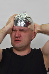 portrait of a man with  tinfoil hat