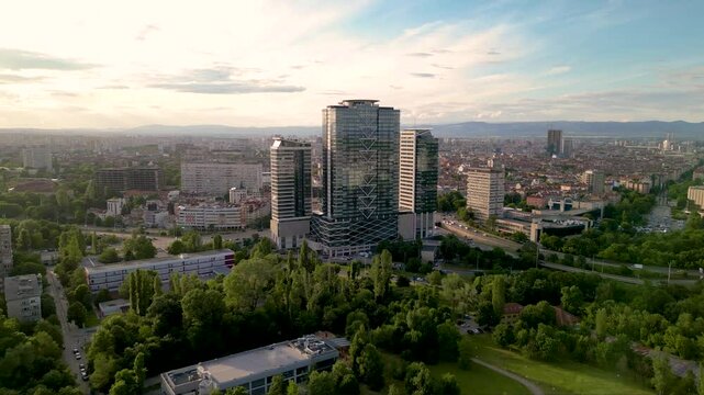 4k Aerial drone footage of Millennium Centre in Sofia, Bulgaria. Skyscraper seen from a drone. Flyover footage of tall building in an urban enrivorment next to a green summer park. Establishing shot.
