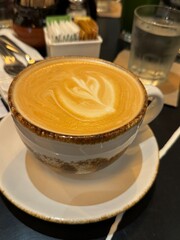 Cup of coffee with cappuccino foam art design