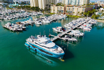Top view of luxury yachts docked at marina. Boats and sailboats line the scenic seashore.
