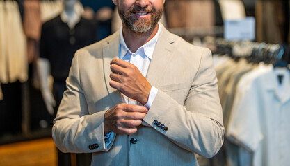 Stylish man in suit. Businessman choose elegant suit in store. Hispanic businessman choosing...
