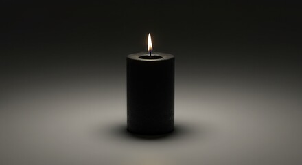 Black candle burning softly in dimly lit background  