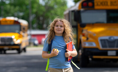 School bus waiting for child student outdoors. Kid with backpack and books to go school. Outdoor...
