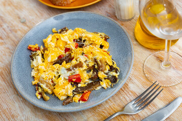 Appetizing omelet with mushrooms and bell peppers served on plate