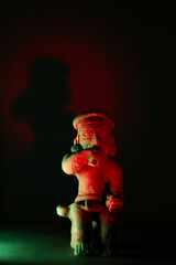 Ancient pre-Columbian ceramic figure in a mystical space that evokes ancestral rituals