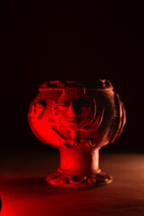 Ancient pre-Columbian ceramic figure in a mystical space that evokes ancestral rituals