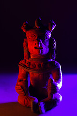 Ancient pre-Columbian ceramic figure in a mystical space that evokes ancestral rituals