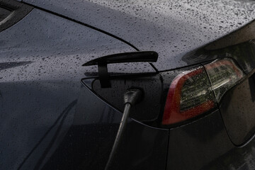 EV Car. Transportation EV. Electric car. Charging Station with the power cable plugged in. Electric...