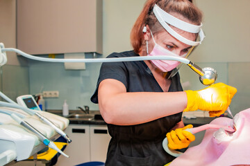 Dentistry. Professional dentist does hardware teeth cleaning with Air Flow for a patient. Ultrasonic teeth cleaning. Prevention and dental hygiene.	