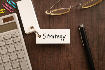 There is word card with the word Strategy. It is as an eye-catching image.