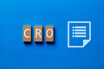 There is wood block with the word CRO. It is an abbreviation for Contract Research Organization as...
