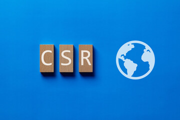 There is wood block with the word CSR. It is an abbreviation for Corporate Social Responsibility as...