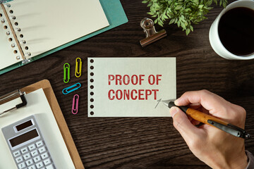 There is a piece of paper with the word Proof of Concept. It is as an eye-catching image.