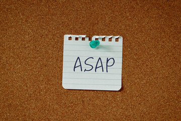 There is a piece of paper with the word ASAP. It is an abbreviation for As soon as possible as eye-catching image.