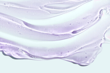 Liquid blue purple gel cosmetic smudge isolated on grey background. Beauty product sample swatch