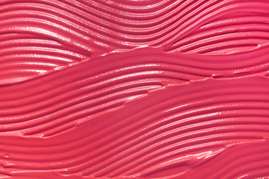 Pink matte or satin finish smeared liquid creamy lipstick background texture nude blusher sample swatch