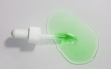 Cosmetic beauty product green nail care oil or cuticle remover. Texture sample stain with pipette...