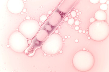 Liquid pink red ampoule gel or serum on white isolated background. Cosmetic beauty product texture...