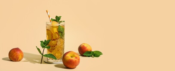 Glass of tasty peach lemonade on beige background with space for text
