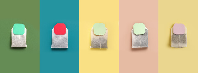 Set of many tea bags on color background, top view
