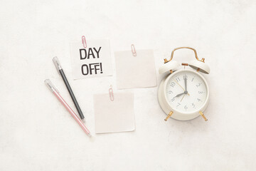 Alarm clock with different stationery on white background