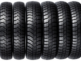 Row of car tires standing upright showing tread pattern