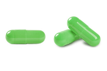 Green capsule pills isolated on white background