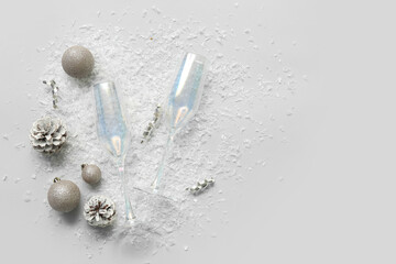 Glasses with painted cones, Christmas balls and serpentine on white background