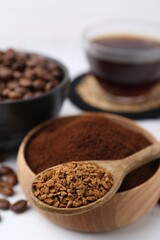 Different types of instant coffee and beans on white table, closeup