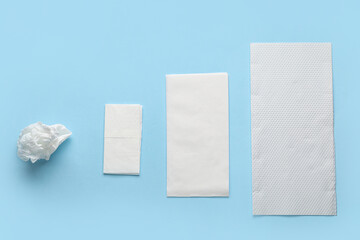 Different paper napkins on blue background