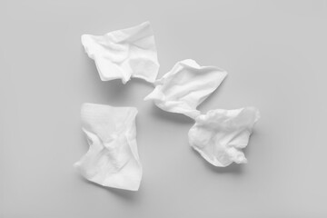 Crumpled paper napkins on grey background