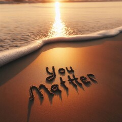 smooth wet beach sand at sunset, with the words 'YOU MATTER' carefully written in the sand