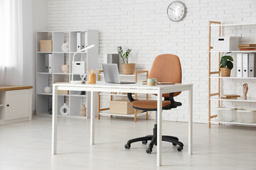 Interior of modern office with workplace and shelf units