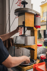 detail of making cendol with a shaved ice machine