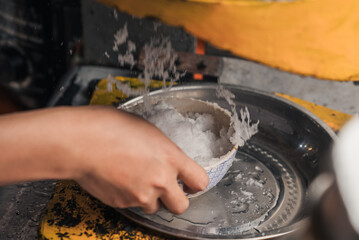 detail of making cendol with a shaved ice machine