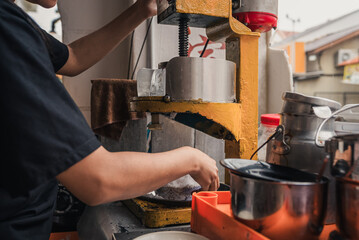 detail of making cendol with a shaved ice machine