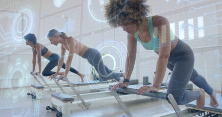 Holding plank woman wearing sports bra and watch in pilates studio with reformers, copy space