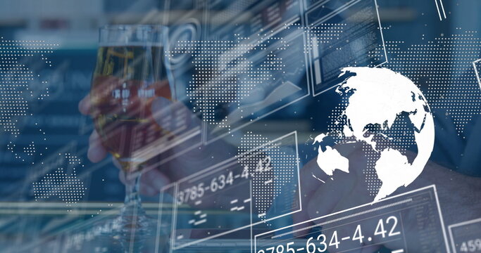 Holding stemmed glass, executive in suit monitoring global data panels at office desk, copy space