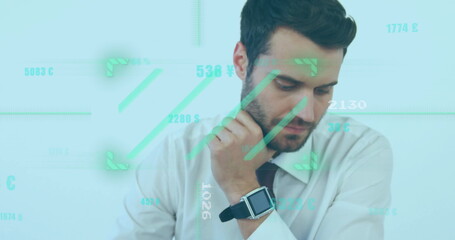 Businessman wearing shirt and tie sitting in office checking smartwatch, with financial graphics