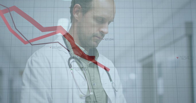 Doctor in white coat, stethoscope analyzing declining red line chart in hospital corridor with grid