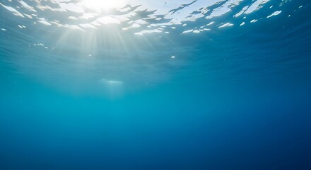 Sunlit Waters Serene Underwater View of the Ocean with Sun Rays Filtering Through the Surface, Offering a Tranquil and Peaceful Scene