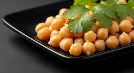 Golden Chickpeas on Black Plate with Cilantro A Culinary Delight for Healthy Eating Enthusiasts