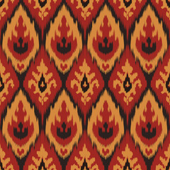 Ikat fabric patterns represent traditional indigenous art.Repeating geometric patterns in shades of dark, yellow, gold and black are perfect for textile designs, rugs, curtains or bohemian and tribal.