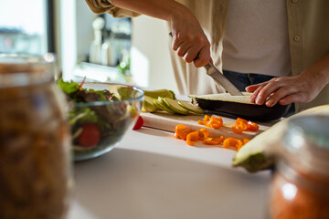 Close up of a woman preparing fresh vegetables for healthy home cooked meal