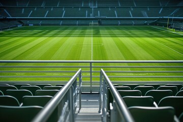 Fototapeta premium Empty stadium, green field, metal railing
