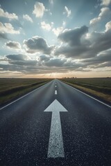 Fototapeta premium Straight empty road leading toward the horizon with a white directional arrow under a dramatic cloudy sky, symbolizing progress, journey, purpose, and new beginnings in life or business