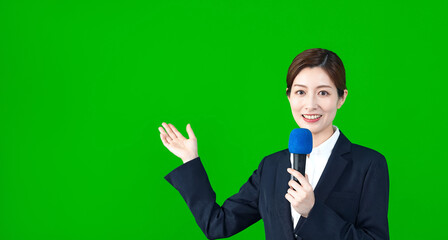 マイクを持って説明する女性レポーター
